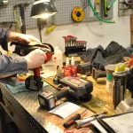 Technician Repairing Power Tools at a Workshop Bench – Fully Tested & Certified Repairs