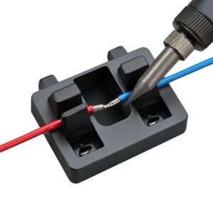 Wire clamp securely holding two colour-coded wires, red and blue, with their exposed ends aligned for soldering as a soldering iron hovers above the joint on a clean white background.