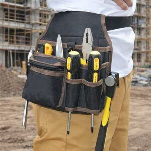 Tool pouch worn on belt with screwdrivers, pliers and hammer at a building site