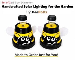 Handcrafted 15cm Dir BeePotts solar garden lights with black and yellow bee design on a white background.
