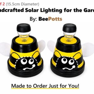 Handcrafted 15cm Dir BeePotts solar garden lights with black and yellow bee design on a white background.