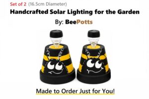 Handcrafted 16.5cm Dir BeePotts solar garden lights with black and yellow bee design on a white background.